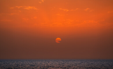 Dubai marina sunset. Beautiful orange sky sunset landscape over the sea from United Arab Emirates.
