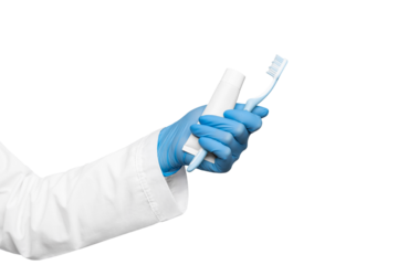 Toothpaste in a tube and a toothbrush in the hand of a dentist on a white background, isolate.