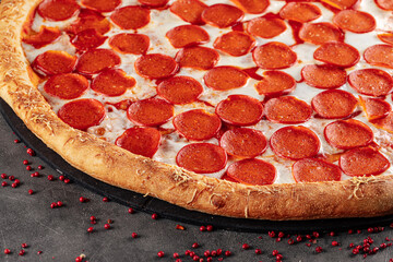 Closeup on freshly baked giant pizza pepperoni with cheese