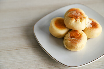 Bakpia cake typical of Yogyakarta with various kinds of fillings served on a plate with tea, coffee and other cakes