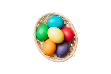 Basket of colorful Easter eggs isolated on white background. Easter basket filled with colored eggs top view holiday concept