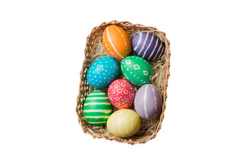 Basket of colorful Easter eggs isolated on white background. Easter basket filled with colored eggs top view holiday concept