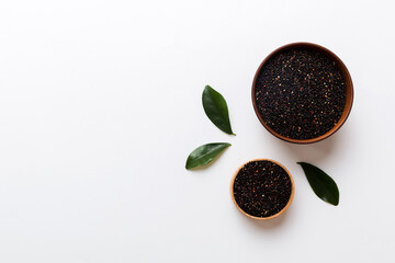 quinoa seeds in bowl on colored background. Healthy kinwa in small bowl. Healthy superfood
