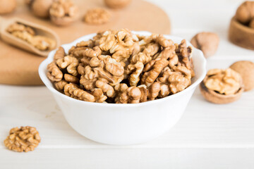 Fresh healthy walnuts in bowl on colored table background. Top view Healthy eating bertholletia concept. Super foods