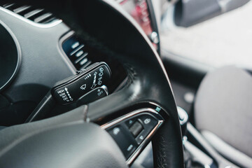 Obraz na płótnie Canvas Modern black car interior, leather steering wheel, climate control, navigation, air ducts, deflectors on the car panel. Details interior. 