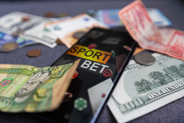 dollars and euros, smartphone with sports bet application
