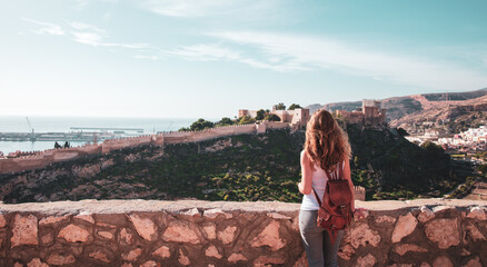 Woman tourist looking at Alcazaba of Almeria- Andalusia in Spain