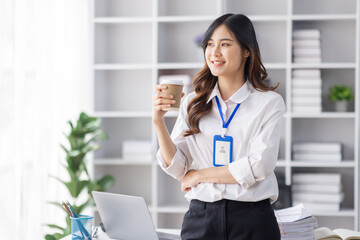 Cheerful business Asian woman freelancer making telephone call share good news about project working in office workplace, employee business finance concept.