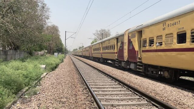 Old train moving on the railroad in Delhi, India