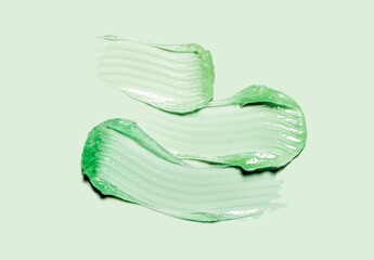 Fototapeta premium Liquid gel cosmetic smudge green vaseline green isolated on pastel