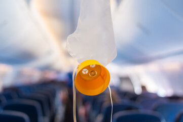 oxygen mask drop from the ceiling compartment on airplane..