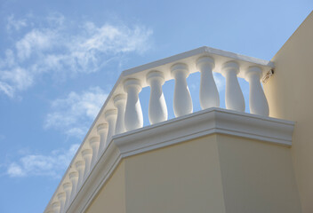 White concrete balustrade on blue sky background.