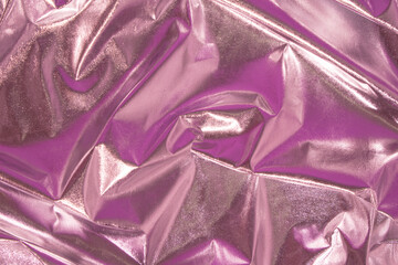 Abstract pink crumpled foil background. Minimal party concept.