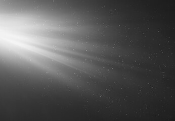 rays of light on a black background with flying particles