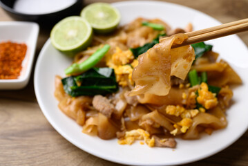Thai food (Pad See Ew), Stir fried rice noodles soy sauce with pork, egg and kale