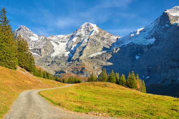 Fototapeta na wymiar Mountains view with Monch peaks from hiking trail near Wengen alpine village in Switzerland.
