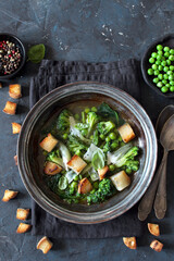 Vegetables soup with toasted bread and parmesan cheese. Top view. Detox food.