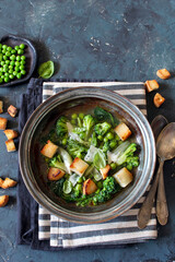 Vegetables soup with toasted bread and parmesan cheese. Top view. Detox food.