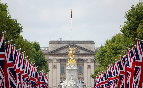London, UK - September 14, 2022: A view of the Victoria Monument and Buckingham Palace in London with Union Jack flags lining the Mall.   