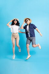 Asian couple traveling image  isolated on blue background