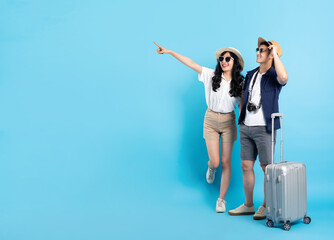 Asian couple traveling image  isolated on blue background