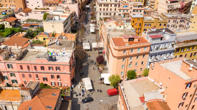 Aerial view of the main street of the Pigneto district in Rome, Italy. It is a pedestrian street in a residential area with many buildings.