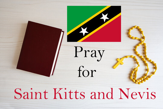 Pray for Saint Kitts and Nevis. Rosary and Holy Bible background.