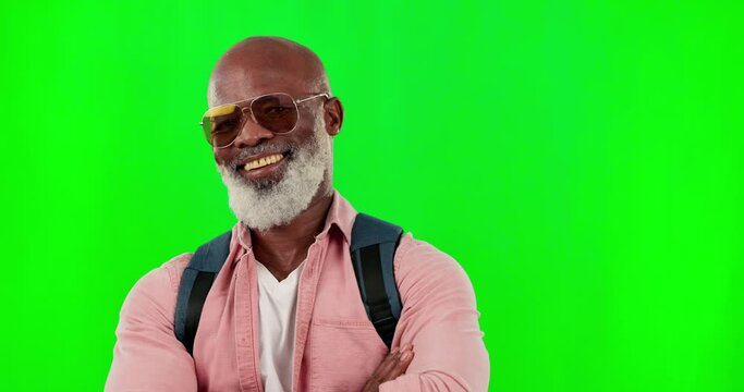 Black man, portrait and smile with sunglasses on green screen with arms crossed and backpack. African senior male model on a studio background with mockup space for fashion, travel and cool attitude