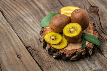 ripe yellow kiwi on a wooden board, banner, menu, recipe place for text, top view