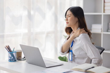 Asian women are stressed or has sore throat at office while working on laptop, Tired asian businesswoman with headache at office, feeling sick at work, copy space