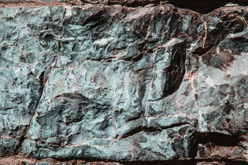 Stone texture of an old rough building wall with cracks, reliefs, plots. Random pattern