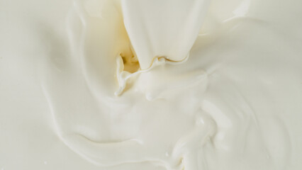 Freeze motion of whirling milk cream, close-up