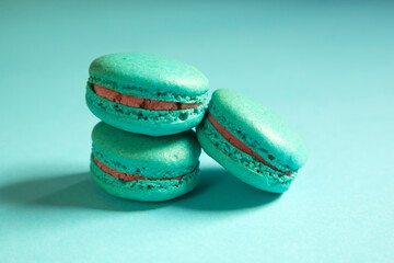 Close-up of macarons cakes of different colors in blue background. Culinary and cooking concept. Tasty colourful macaroons.