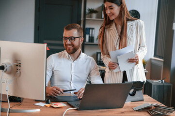 Obraz premium Designers are talking and working. Two employees are together in the modern office