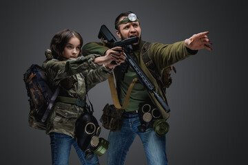 Fototapeta premium Studio shot of post apocalyptic girl teenager and man surviving after armageddon.