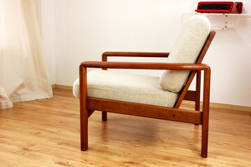 Armchair with Ottoman Danish Design in a Cosy Modern Furnished Living Room 60s Style Interior with a Wall Shelf and a Typewriter in the Background Orange Lamp wooden floor
