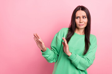 Photo of young stressed woman brunette hair wear green sweatshirt hands restriction discrimination...