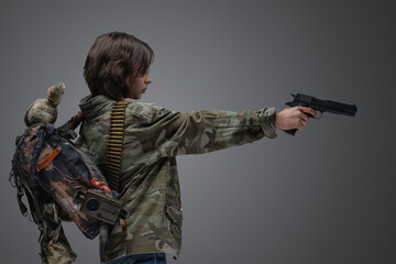 Portrait of young girl survived after global disaster dressed in camouflage jacket.