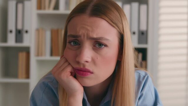 Close up portrait stress offended woman boring dissatisfied looking at camera shake head no rejection deny. Headshot Caucasian girl bored with work office student stressful sad upset annoyed grimace