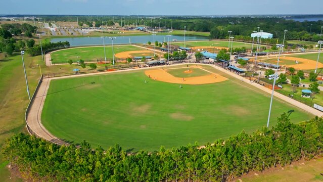Two Competitive Baseball Teams Taking Their Positions After An Inning During The Game In Florida, USA. - Slow Aerial Pullback