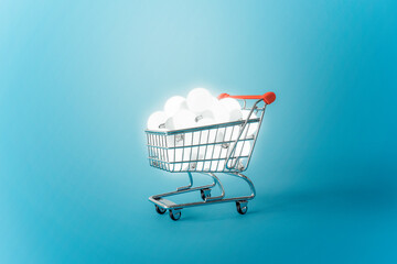 Shopping trolley with many burning light bulbs