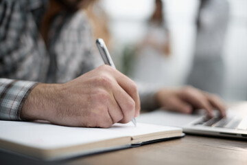 Businessman signing a document after reading the agreement in office