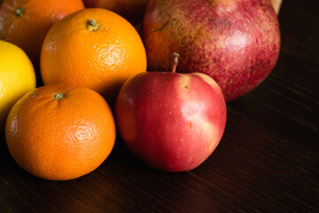 Fruit in a reusable bag. Earth day and zero waste concept. Apple, orange and pomegranate close-up on a dark background