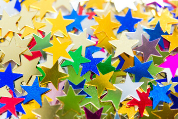 Multi-colored shining stars close-up. Festive holiday background.