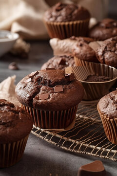 Chocolate muffins on gray wooden tray