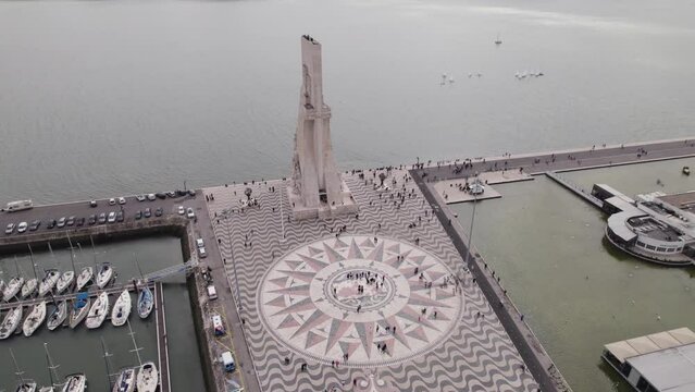 Aerial view orbiting Padr&atilde;o dos Descobrimentos mosaic world map and compass sculpture on the Tagus river estuary, Lisbon