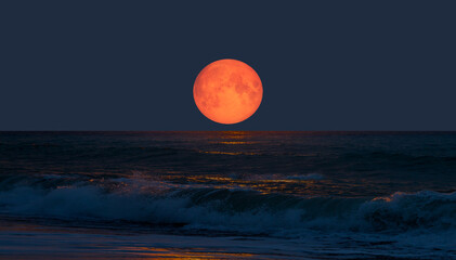 Super moon. Colorful sky with cloud and bright full moon over seascape.