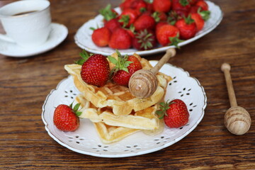 Belgian waffles with fresh berries strawberry , honey and cappuccino coffee for breakfast
