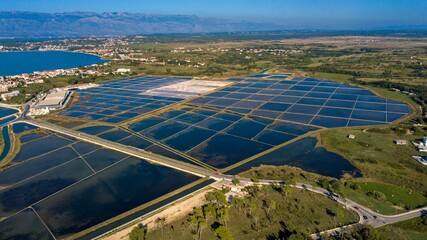 Drone view of Solana Nin Salt Museum in Nin, Croatia with greenery and mountains around