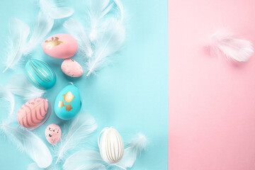 Obraz na płótnie Canvas easter decorations feathers sequins pink and white easter eggs on pastel blue background. Easter background